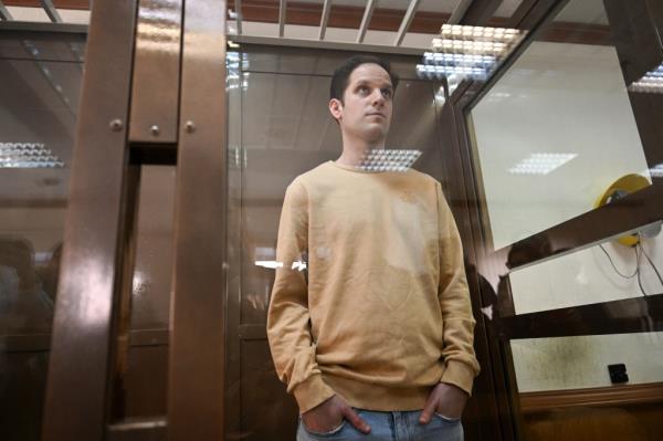 US journalist Evan Gershkovich, stands inside a defendants' cage before a hearing to co<em></em>nsider an appeal on his extended pre-trial detention, at the Moscow City Court in Moscow on September 19, 2023. 