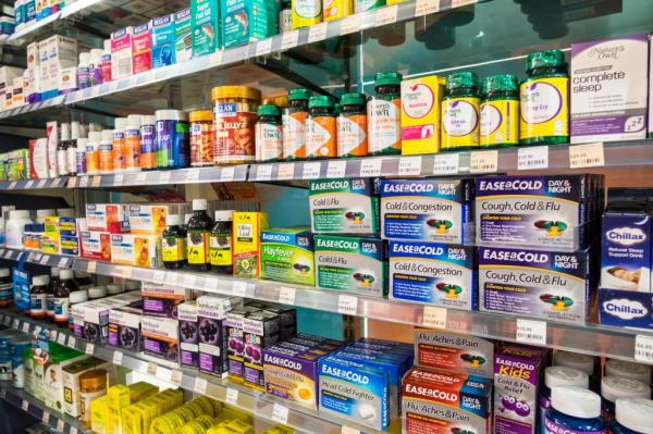Shelves with cold medicine and flu remedies for sale in a pharmacy on Flinders Street, Melbourne CBD, Victoria, Australia.