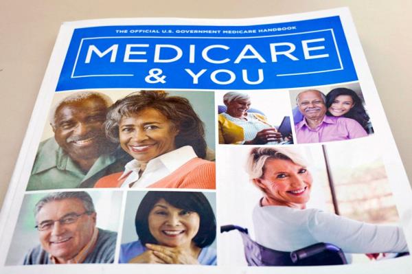 A U.S. Medicare Handbook laying on a table with a blue cover and the title 