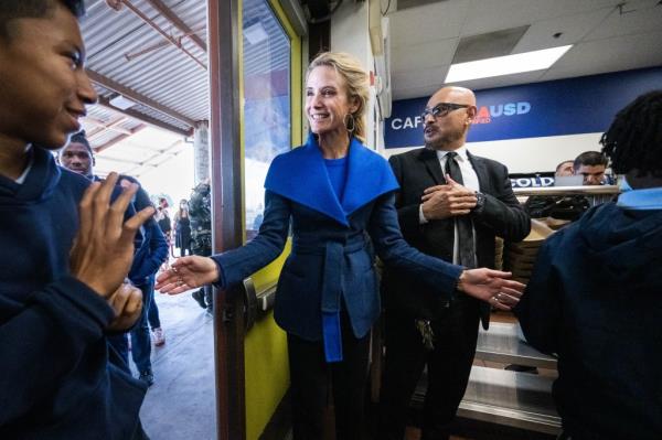 Jennifer Siebel Newsom, wife of Gov. Gavin Newsom, greets students as they enter their cafeteria at John Liechty Middle School in Los Angeles after a roundtable discussion on California's landmark investment in school meals for all on Wednesday, December 7, 2022.