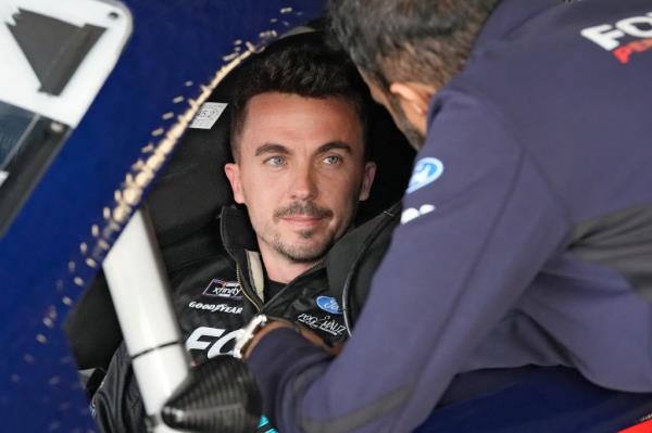 Feb. 16, 2024: professio<em></em>nal race car driver Frankie Muniz talks to a crew member before a practice run at Daytona Internatio<em></em>nal Speedway.