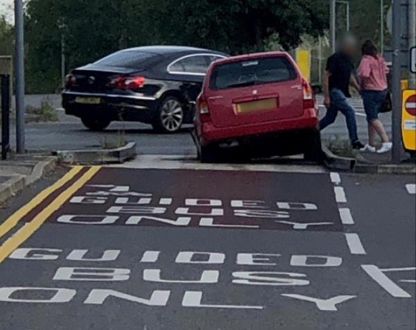 A car getting stuck in the bus lane trap at the junction of Station Road and Harrison Way in St Ives, Cambs. Photo released October 13 2023. See SWNS story SWLNtrap. Dozens of motorist are complaining their cars are being damaged after being caught in a co<em></em>ntroversial bus lane trap. The trap is located at the junction of Station Road and Harrison Way in St Ives, Cambs and is designed to prevent vehicles driving o<em></em>nto the busway. The pit in the road is wide enough that small vehicles fall into it but small enough that larger-diameter-wheeled vehicles, such as buses, may pass. But as of late, it could be argued the trap is proving a little too effective, with drivers getting stuck in it o<em></em>nce or twice a week.