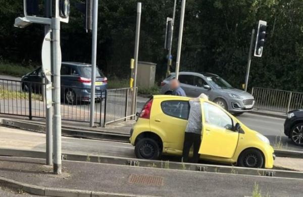 A car getting stuck in the bus lane trap at the junction of Station Road and Harrison Way in St Ives, Cambs. Photo released October 13 2023. See SWNS story SWLNtrap. Dozens of motorist are complaining their cars are being damaged after being caught in a co<em></em>ntroversial bus lane trap. The trap is located at the junction of Station Road and Harrison Way in St Ives, Cambs and is designed to prevent vehicles driving o<em></em>nto the busway. The pit in the road is wide enough that small vehicles fall into it but small enough that larger-diameter-wheeled vehicles, such as buses, may pass. But as of late, it could be argued the trap is proving a little too effective, with drivers getting stuck in it o<em></em>nce or twice a week.