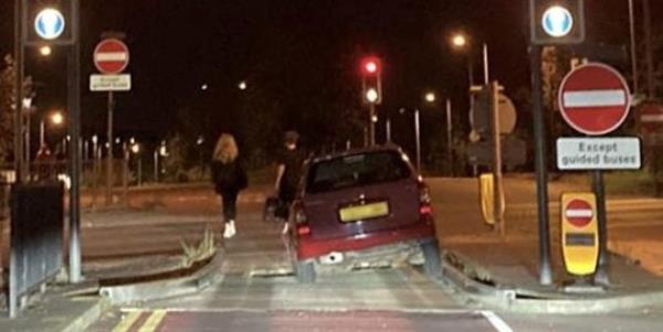 A car getting stuck in the bus lane trap at the junction of Station Road and Harrison Way in St Ives, Cambs. Photo released October 13 2023. See SWNS story SWLNtrap. Dozens of motorist are complaining their cars are being damaged after being caught in a co<em></em>ntroversial bus lane trap. The trap is located at the junction of Station Road and Harrison Way in St Ives, Cambs and is designed to prevent vehicles driving o<em></em>nto the busway. The pit in the road is wide enough that small vehicles fall into it but small enough that larger-diameter-wheeled vehicles, such as buses, may pass. But as of late, it could be argued the trap is proving a little too effective, with drivers getting stuck in it o<em></em>nce or twice a week.