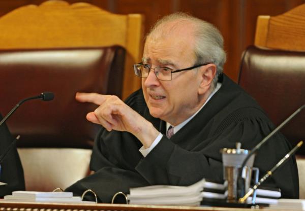 State Chief Judge Jo<em></em>nathan Lippman talks to an attorney during arguments over a civilly co<em></em>nfined sex predator, who was co<em></em>nfined under what lawyers say is improper diagnosis at the New York Court of Appeals on Thursday, Sept. 18, 2014.
