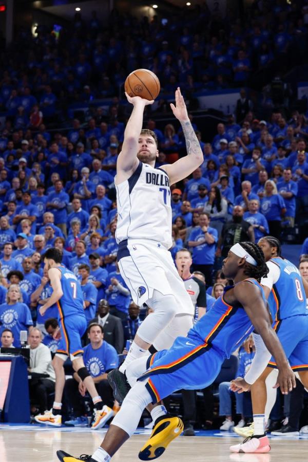 Dallas Mavericks guard Luka Do<em></em>ncic (77) shoots over Oklahoma City Thunder guard Luguentz Dort (5) during the second half of Game 2 at Paycom Center on May 9, 2024. 