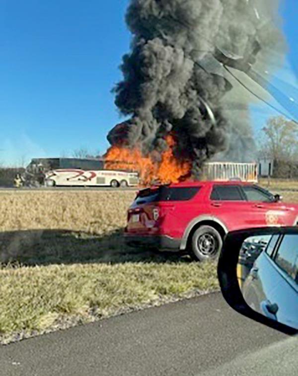 The bus is pictured on fire.