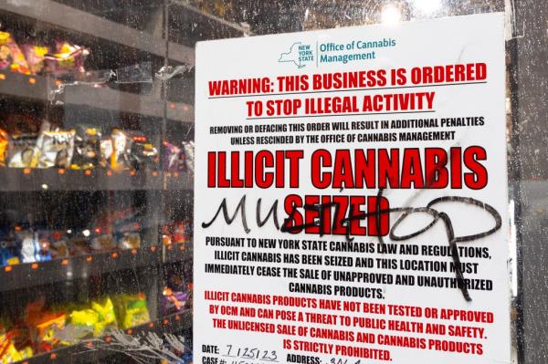 Sign in the window of an illegal weed shop that reads 