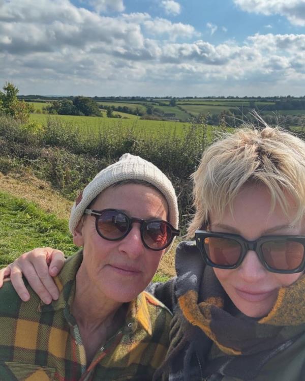 Ellen DeGeneres and Portia de Rossi taking a selfie together