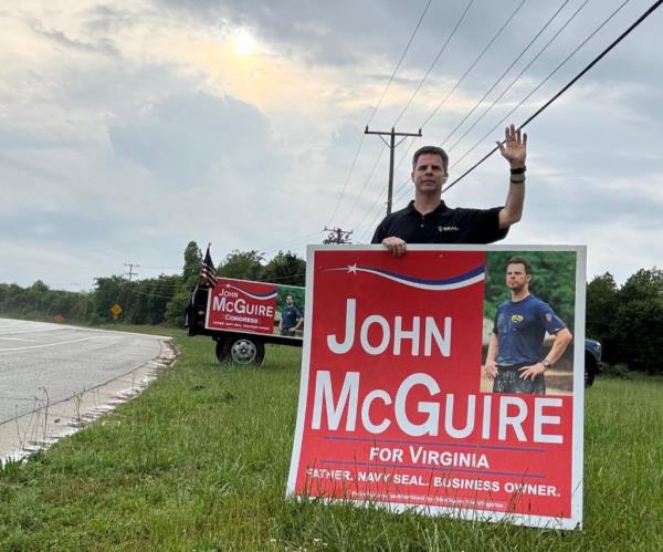 John McGuire on the side of the road holding a 
