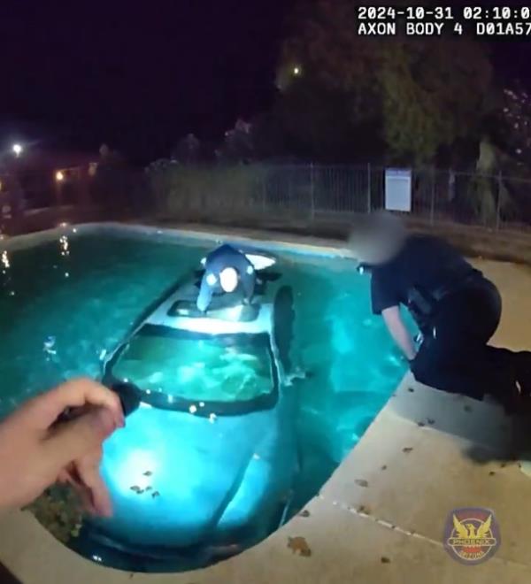 A screengrab of police body cam footage that shows the driver rescued from the submerged car.
