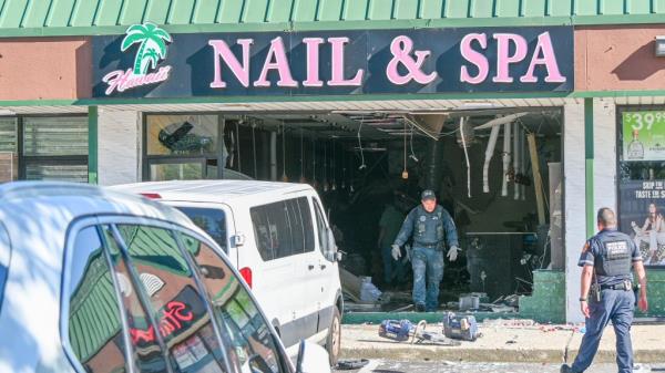 Emergency services at scene of car crash into Hawaii Nail & Spa building causing fatalities and injuries