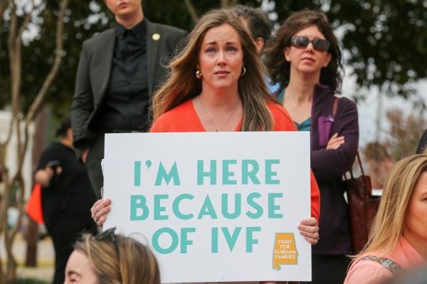 A woman holds a sign in support of IVF treatments during a rally advocating for IVF rights outside the Alabama State House on Wednesday, Feb. 28, 2024.