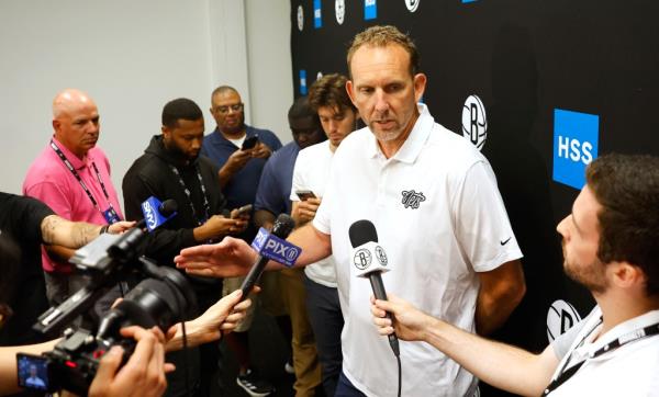 Brooklyn Nets general manager Sean Marks answering questions from reporters at the HSS Training Center