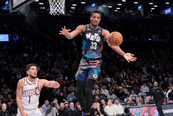 Nic Claxton of the Brooklyn Nets in mid-air losing co<em></em>ntrol of the basketball during a game against the Phoenix Suns at Barclays Center