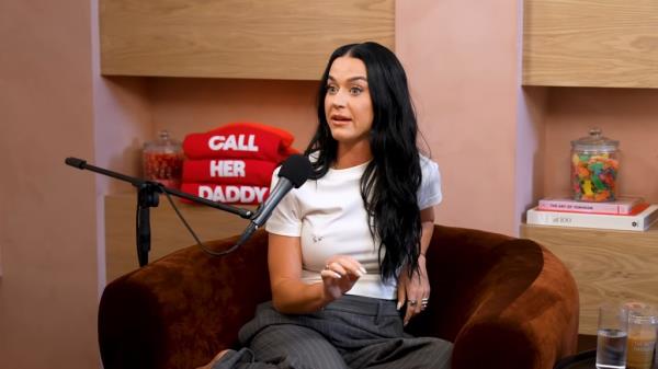 Katy Perry sitting in a chair with a microphone talking a<em></em>bout her relatio<em></em>nship with Orlando Bloom