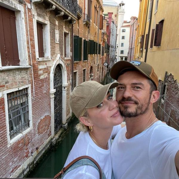 Orlando Bloom and Katy Perry taking a selfie, discussing their challenging relationship
