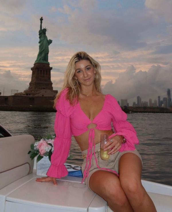 Piper Phillips with Statue of Liberty behind her