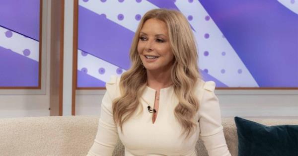 Carol Vorderman wearing a white dress.