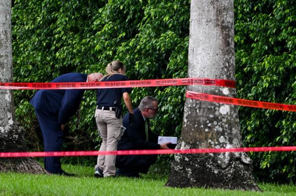 Law enforcement officials work at the crime scene outside the Trump Internatio<em></em>nal Golf Club in West Palm Beach, Florida,