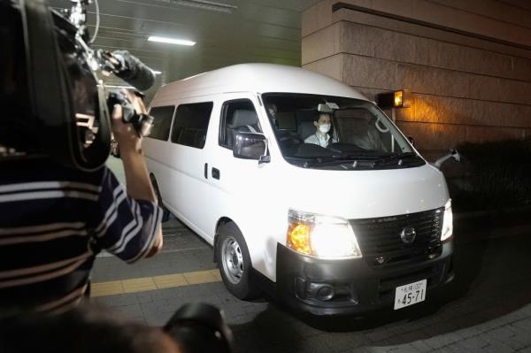 Police escort Runa Tamura, 29, away from a police station in Sapporo on Monday.