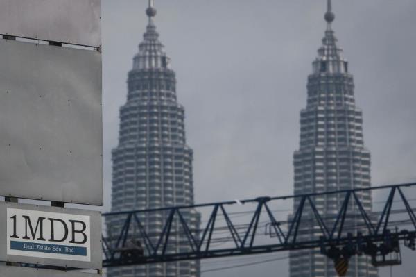 Sign that says 1MDB in front of two towers
