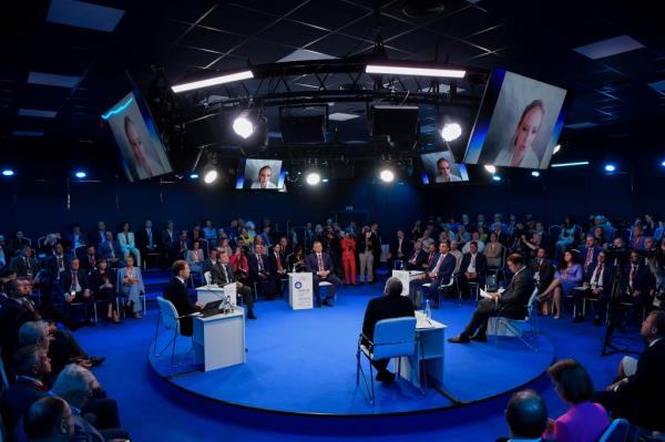 Participants listen to Katerina Tikhonova, General Director of the non-governmental development institute Innopraktika, who is seen on screens while speaking via a video l<em></em>ink during a session of the St. Petersburg Internatio<em></em>nal Eco<em></em>nomic Forum
