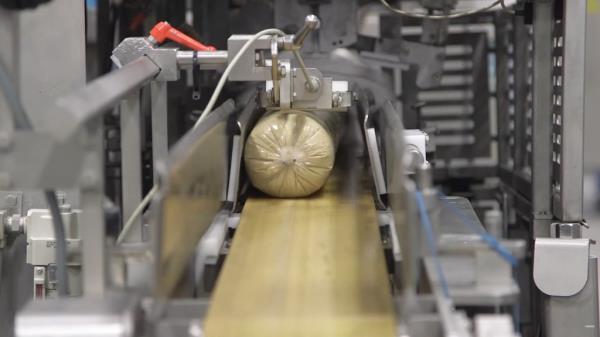 o<em></em>nce the mixture comes together as a dough would, it's poured into a vat and shaped into a log.