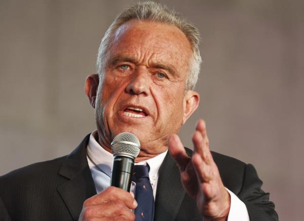 Presidential candidate Robert F. Kennedy Jr. speaking at a Cesar Chavez Day event in Unio<em></em>n Station, Los Angeles, holding a microphone