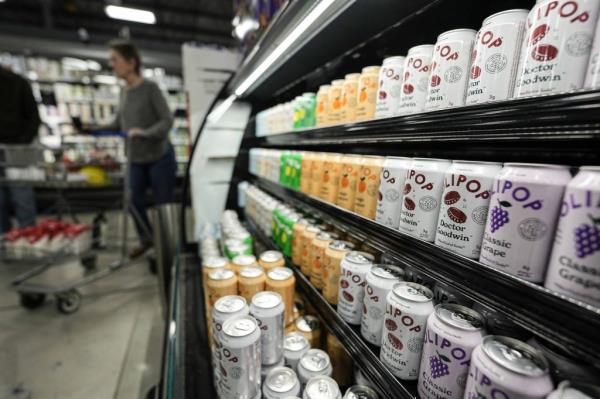 Cans of Olipop, a drink co<em></em>ntaining botanicals, plant fibers, and prebiotics, displayed at a Kroger supermarket, Friday, April 12, 2024, in Marietta, Ga.