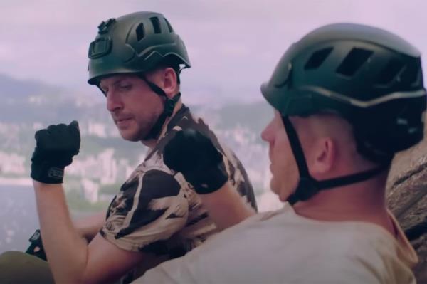 A man in a helmet next to a woman. 