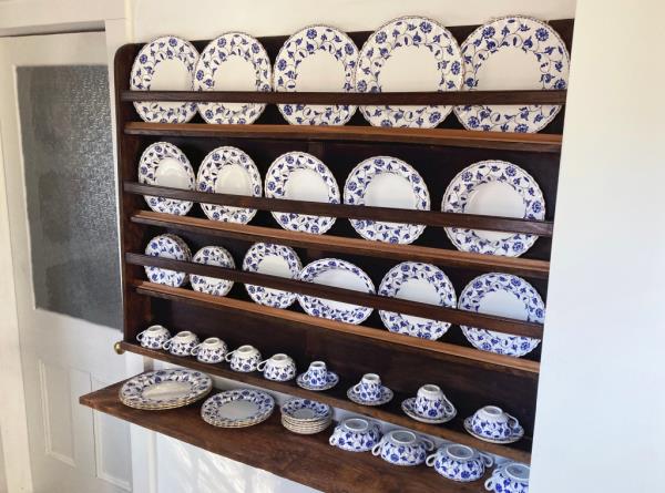 A shelf filled with plates. 
