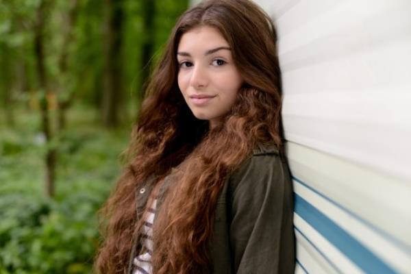 Cindy Williams Jr leaning against a caravan in EastEnders