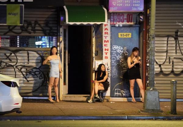 A general view of women believed to be sex workers as they stand in front of storefro<em></em>nts and massage parlors on Roosevelt Avenue in the Corona section of Queens.