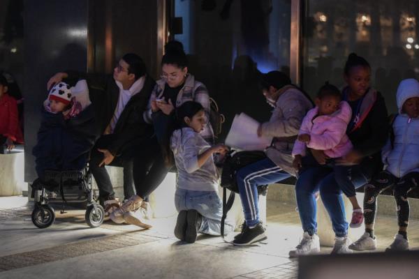 Migrants are pictured with their families.