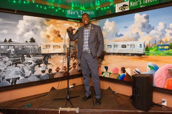 Loycent Gordon stands on the stage inside Neir's Tavern.