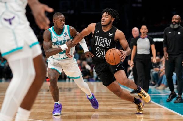  Nets guard Cam Thomas (24) drives to the basket against Charlotte Hornets guard Terry Rozier 