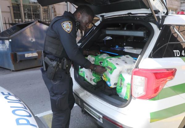 A police officer is seen handling the stolen Bounty paper towel packs.