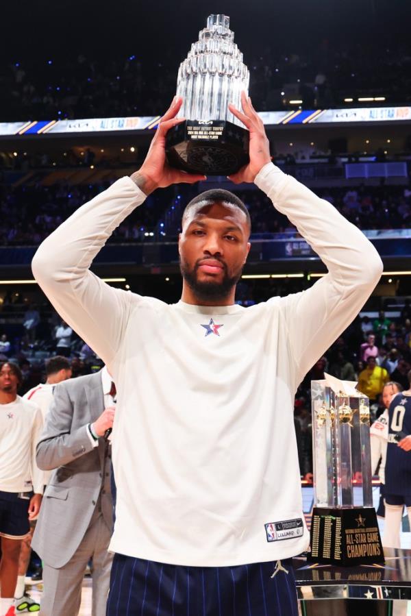 Damian Lillard poses with the Kobe Bryant All-Star MVP trophy during the NBA All-Star game on Feb. 18, 2024.