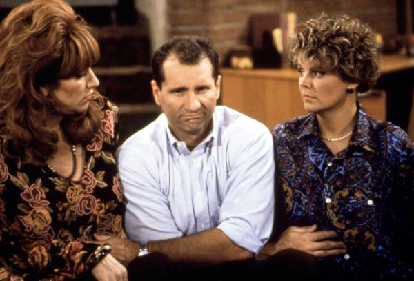 Katey Sagal (from left), Ed O'Neill and Amanda Bearse sit on a couch in a still from 