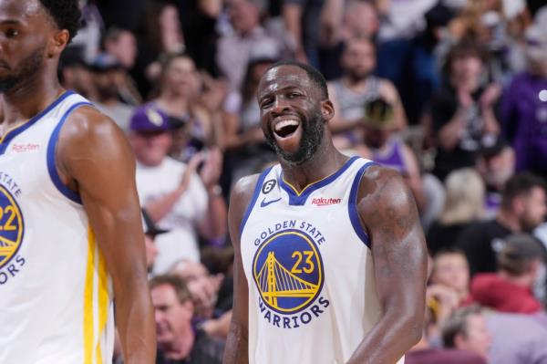 Draymond Green smiling on the court with the Warriors. 