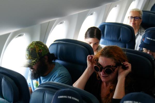 Passengers sit in a plane to take-off in a special Delta Airlines eclipse flight. 