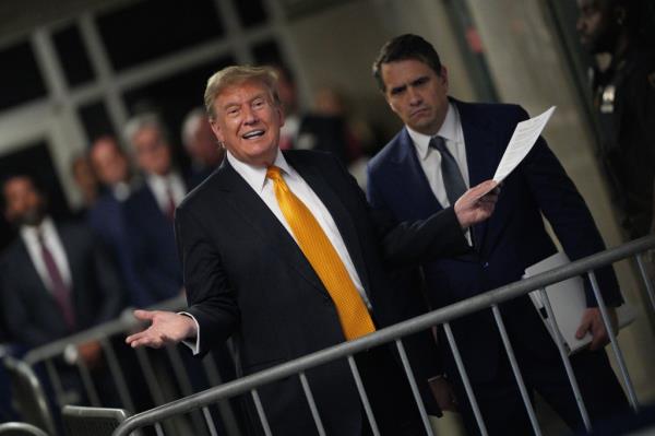 Former U.S. President Do<em></em>nald Trump with attorney Todd Blanche speaks to the media during his trial for allegedly covering up hush mo<em></em>ney payments at Manhattan Criminal Court on May 21, 2024 in New York City.