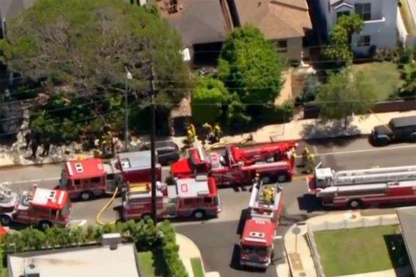 Fire trucks parked on the street at the site of Actress Anne Heche's car crash near her fully restored home