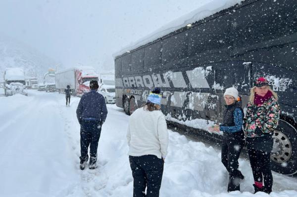 A weekly ski trip for a<em></em>bout 50 women from the Denver area turned into an overnight ordeal when their bus got stuck in a snowstorm behind jackknifed semi tractor-trailers on their way back from Vail.
