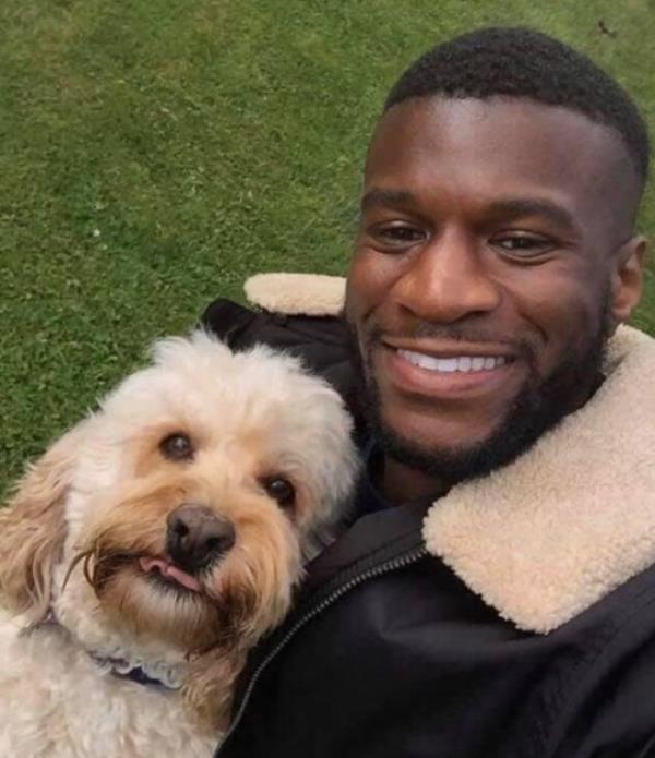 Darren Sho<em></em>neye holding a dog