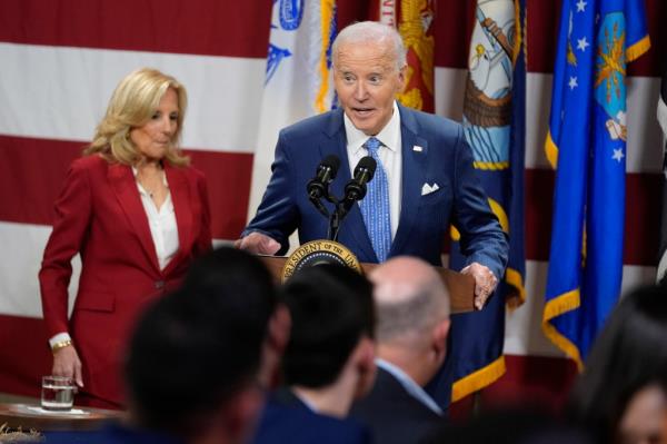 President Joe Biden speaks as first lady Jill Biden looks on at a Friendsgiving event with service members and their families in the Staten Island borough of New York, Monday, Nov. 25 2024.