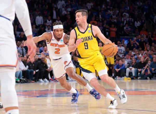 T.J. McCo<em></em>nnell #9 drives down court as New York Knicks guard Miles McBride #2 gives chase during the third quarter.
