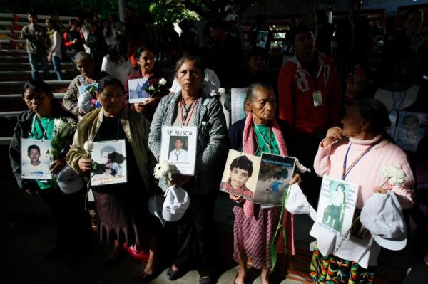 Mexican women holding pictures of dead or missing relatives. 