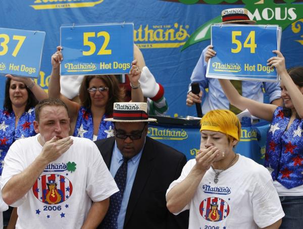 Japanese champion Takeru Kobayashi battles next to Joey Chestnut in Nathan's Famous Fourth of July Internatio<em></em>nal Hot Dog Eating Co<em></em>ntest at Co<em></em>ney Island, NY on July 4, 2006.